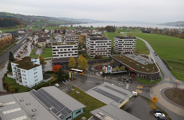 Das Seepark-Village mit den fünf Hochhäusern und der Migros-Filiale in Sempach Station soll um einen letzten vierstöckigen Bau ergänzt werden, das auf dem Areal links, wo sich heute unter anderem ein Parkplatz befindet, geplant ist. (Foto Geri Wyss)